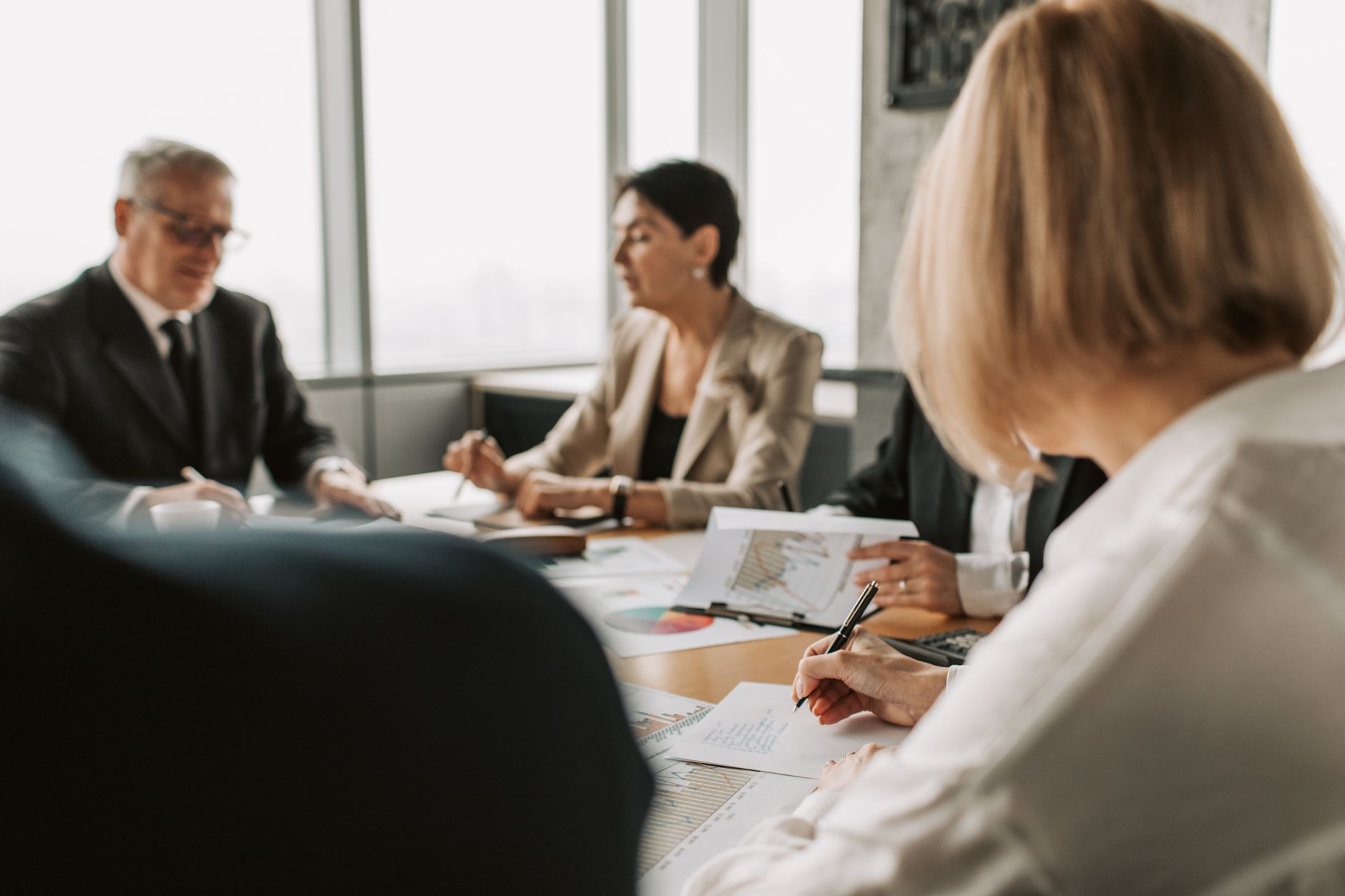Colleagues working through documents at a meeting table